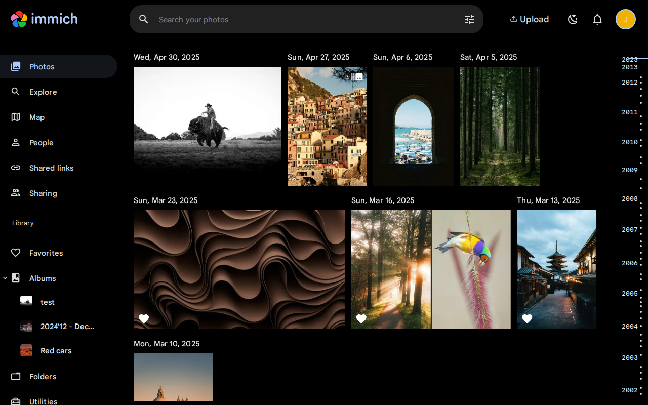 Immich web interface showing the photo library with albums, timeline view, and AI-powered search